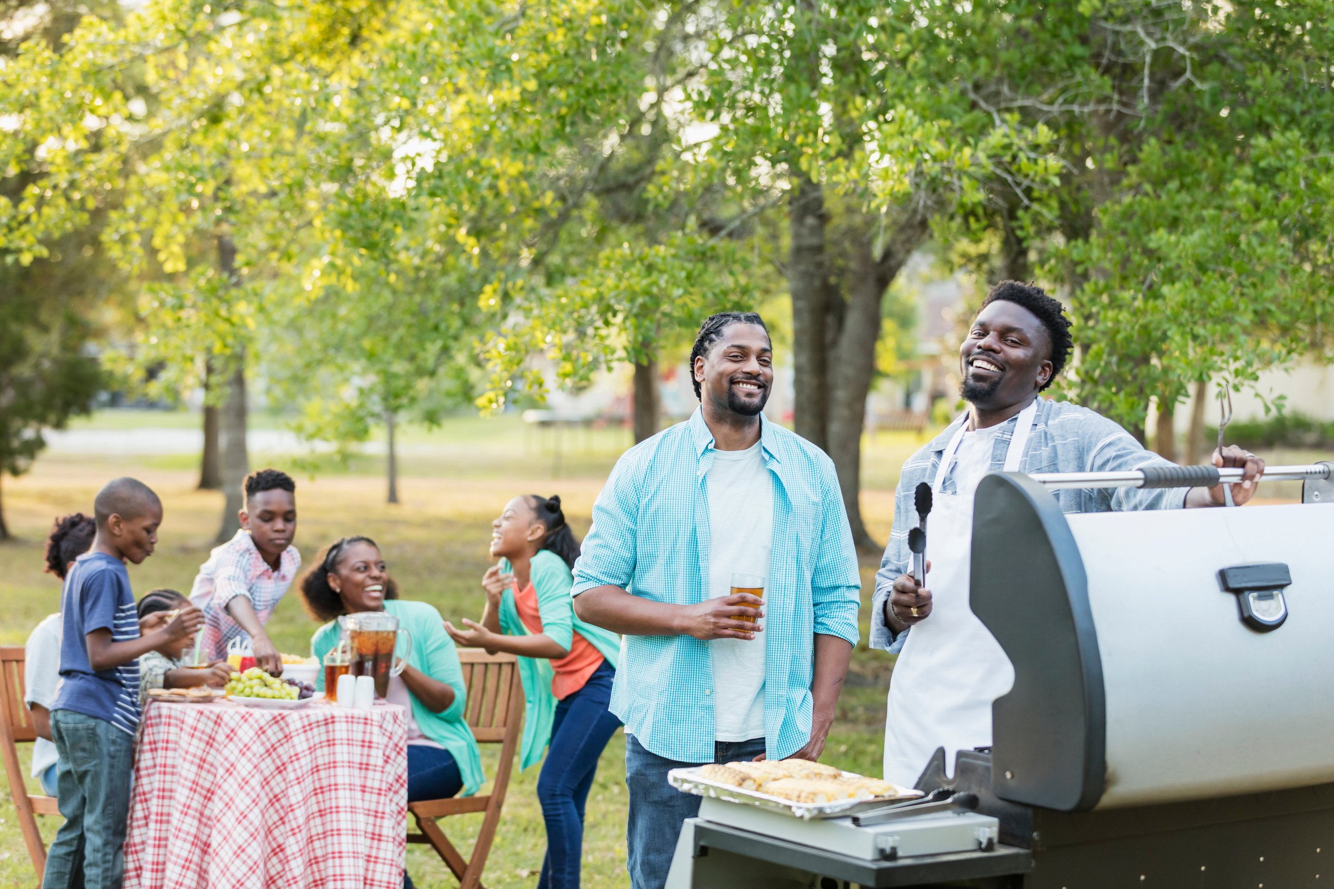 Large African-American family having backyard cookout